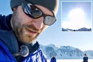 A man in sunglasses and a hat standing on a snowy mountain