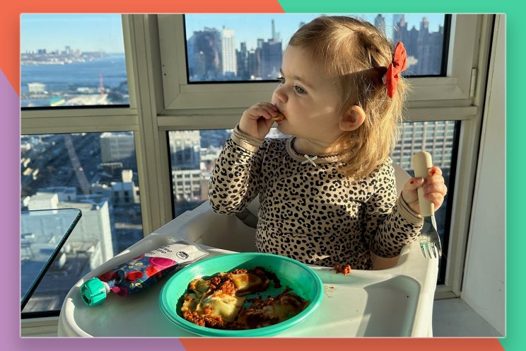 A child eating food in a high chair