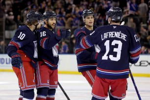 Alexis Lafreniere (No. 13), Vincent Trocheck (No. 16) and Artemi Panarin (No. 10) react during the Rangers-Penguins game on Dec. 4, 2024. 