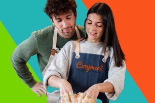 Petra Vlhová cooking with a man in aprons