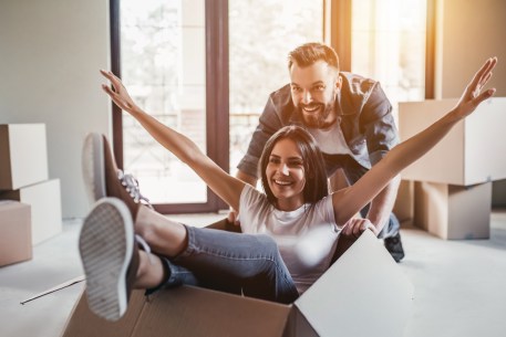 A young couple celebrates their new home.