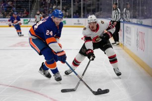 Scott Mayfield (L.) fights for the puck during the Islanders-Senators game on Jan. 14, 2025. 