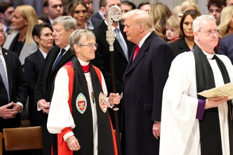 President Donald Trump stands near Reverend Mariann Edgar Budde as he attends the National Day of Prayer Service at the Washington National Cathedral in Washington, U.S., January 21, 2025.