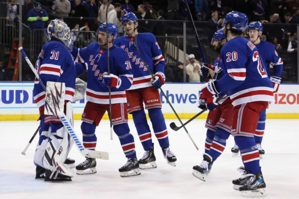 Rangers players congratulate Igor Shesterkin after their 5-0 shutout win over the Senators on Jan. 21, 2025.