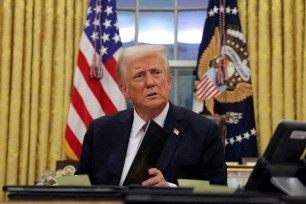 President Donald Trump signs documents as he issues executive orders and pardons for Jan. 6 defendants in the Oval Office at the White House on Inauguration Day in Washington, U.S., January 20, 2025.